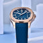 Blue watch with rose gold case on a light blue geometric background
