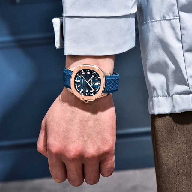 Person wearing a PD-YS031 watch with a blue strap against a blurred background