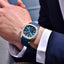 Person wearing a PD-YS031 with a blue strap and blue dial, dressed in formal attire.